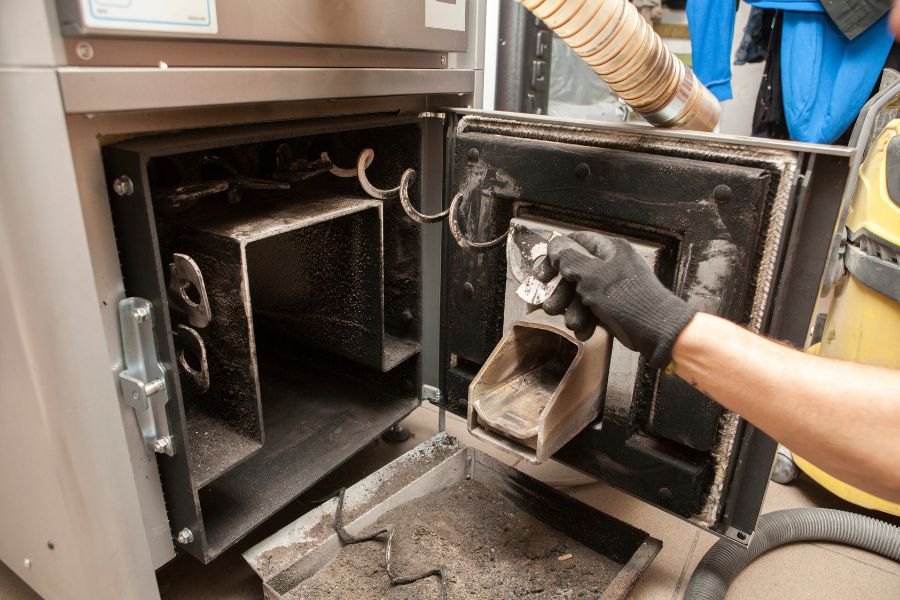 Someone cleaning a stove